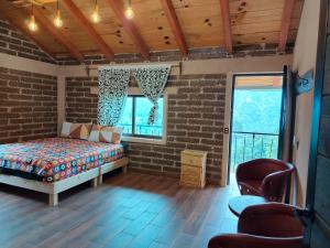 una camera da letto con un letto in un muro di mattoni di cabañas Ticomulco a Zacatlán