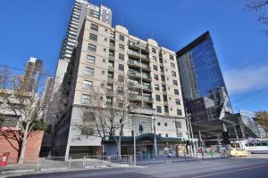 a tall white building on a city street at HarbourView Apartment Hotel (now Arrow on Spencer) in Melbourne