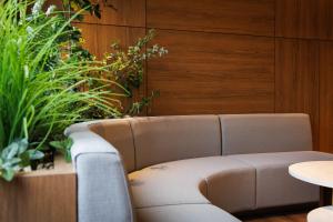 a couch in a room with plants and a table at JR-East Hotel Mets Shibuya in Tokyo