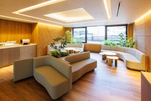 a living room with couches and a table at JR-East Hotel Mets Shibuya in Tokyo