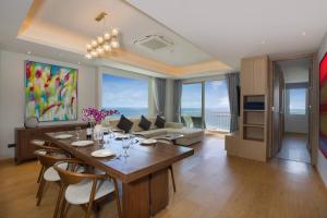 a living room with a table and chairs and a couch at Chic Design & Full Seaview 2BR Karon Condo 16C, near Beach in Karon Beach