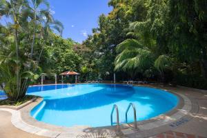 a large blue swimming pool with palm trees at Chic Design & Full Seaview 2BR Karon Condo 16C, near Beach in Karon Beach