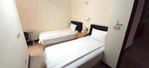 Postel nebo postele na pokoji v ubytování 大新民宿Da Xin Homestay