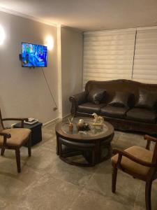 a living room with a couch and a coffee table at Departamento plaza club Temuco in Temuco