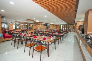 a dining room with tables and chairs in a restaurant at Golden Tulip Essential Tangerang in Tangerang