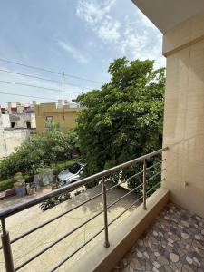 a balcony with a railing and a car on a street at Luxury Appartment Radha Kunj in Vrindāvan