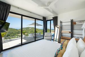 a bedroom with a bed and a view of a patio at Pahili Pool Villas Koh Phangan in Mae Haad +90 photos