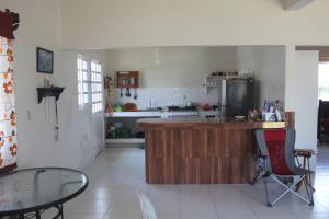 a kitchen with a counter and a table in it at Casa Esmeralda in Tecolutla