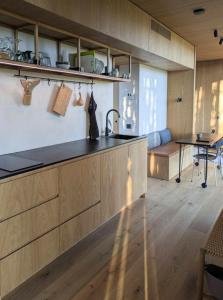 a kitchen with a counter top and a table at Tiny House Overlooking Nature in Vordingborg +21 photos