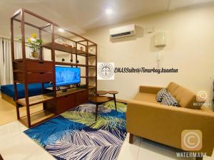 a living room with a couch and a tv at EMAS Suite Timurbay, Kuantan in Kuantan