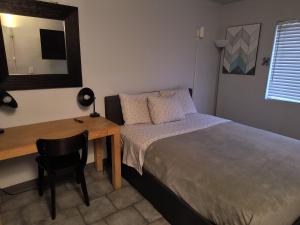 a bedroom with a bed and a desk with a mirror at 1 bdrm plus bathroom Condo in Las Vegas
