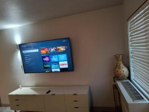 a flat screen tv hanging on a wall at 1 bdrm plus bathroom Condo in Las Vegas