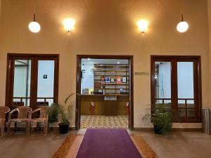 a lobby with two doors and a purple rug at HOTEL DWARA in Subrahmanya