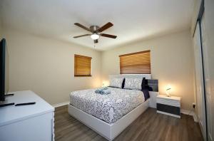 a bedroom with a bed and a ceiling fan at Villa On The Ocean in Fort Pierce