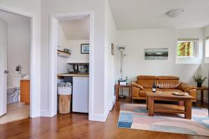 a living room with a couch and a table at Liahona Guest House in Ucluelet