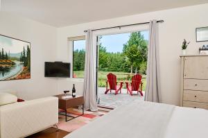 a bedroom with a bed and a sliding glass door at Liahona Guest House in Ucluelet