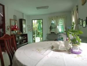 a living room with a table with a plate of tea cups at Young and Beautiful in Bangkok