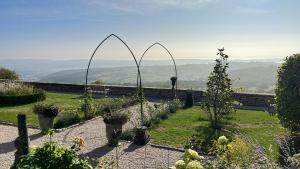 a person standing in a garden with a view at Charming Gite In Mont Saint Vincent in Mont-Saint-Vincent