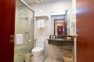 a bathroom with a toilet and a sink and a shower at GreenTree Inn Shanghai Songjiang Xinqiao Jiuxin Road Express Hotel in Chunshen +89 photos