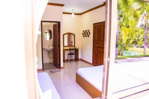a view of a bedroom with a bed and a table at TAWANCHAY HOTEL PHATTHALUNG in Ban Tha Khae (1) +62 photos