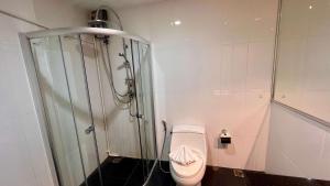 a bathroom with a shower and a toilet at Stylish Loft Condo in Boat Avenue Phuket in Ban Thalat Choeng Thale