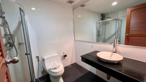a bathroom with a toilet and a sink and a shower at Stylish Loft Condo in Boat Avenue Phuket in Ban Thalat Choeng Thale