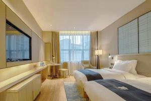 Katil atau katil-katil dalam bilik di Echarm Hotel Liuzhou High-speed Railway Station +277 gambar