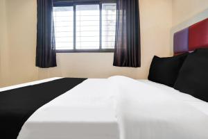 Postel nebo postele na pokoji v ubytování Hotel Orange Residency