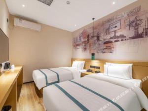 Postel nebo postele na pokoji v ubytování City Comfort Inn Jinan West Station Shandong International Convention and Exhibition + 198 fotografií