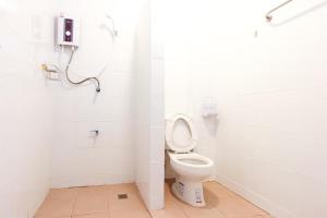 a white bathroom with a toilet and a shower at SC Palace Chiangrai Hotel in Chiang Rai +27 photos
