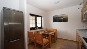 A kitchen or kitchenette at Vila Olympia - Apartmán Olympia 3 Még 25 kép