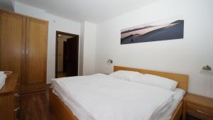 A bed or beds in a room at Vila Olympia - Apartmán Olympia 3