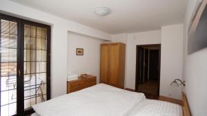 A bed or beds in a room at Vila Olympia - Apartmán Olympia 3