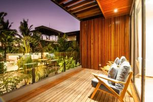 a patio with a rocking chair on a wooden deck at New 4BR Villa 200m to the beach Canggu in Canggu