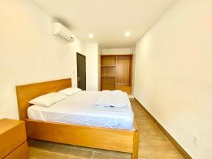 Ένα ή περισσότερα κρεβάτια σε δωμάτιο στο Phu Nhuan Cultural Park Apartment