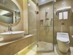a bathroom with a sink and a toilet and a shower at Vienna Hotel Beijing Fangshan District Guangyangcheng Metro Station in Wangzhuang +168 photos