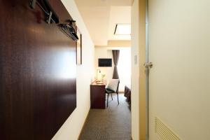 a hallway with a room with a desk and a table at Hotel Sho Sapporo - Vacation STAY 53624v in Sapporo