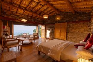 a bedroom with a bed and a living room at Kot Kailash Kumaon in Almora