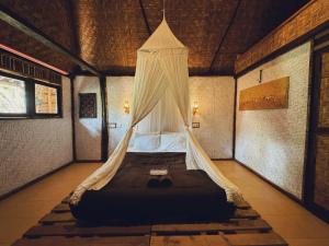 A bed or beds in a room at Sasak Experience