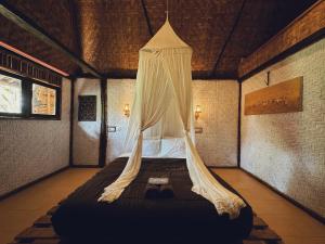 A bed or beds in a room at Sasak Experience