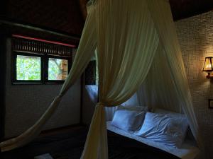 A bed or beds in a room at Sasak Experience