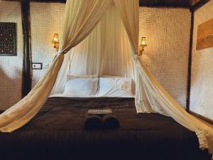 A bed or beds in a room at Sasak Experience