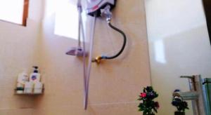 an umbrella hanging on the wall of a bathroom at New Lao Paris Hotel in Vientiane +88 photos
