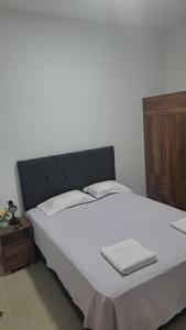 a bedroom with a large bed with white towels on it at Departamento amoblado in Iquitos