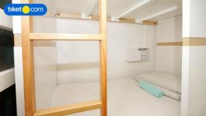 a small room with a bunk bed and a ladder at Royal Hostel Singapore in Singapore +165 photos