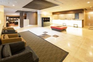 a lobby with couches and a couch and a table at HOTEL MYSTAYS Ueno East in Tokyo