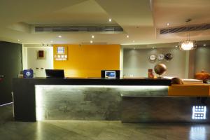 a lobby with a counter with a laptop on it at Horizon Inn in Taipei
