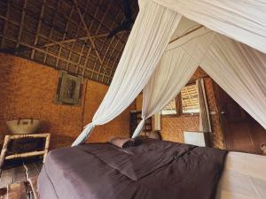 A bed or beds in a room at Sasak Experience