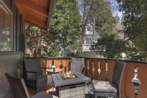 a patio with chairs and a fire pit on a balcony at The Lazy Bear Cabin - For 6 in Crestline