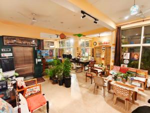 a restaurant with tables and chairs in a room at Devi music ashram in Rishīkesh